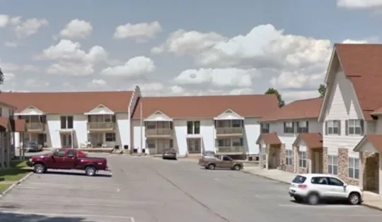 a google street view image of a parking lot at The Country Oaks Apartments