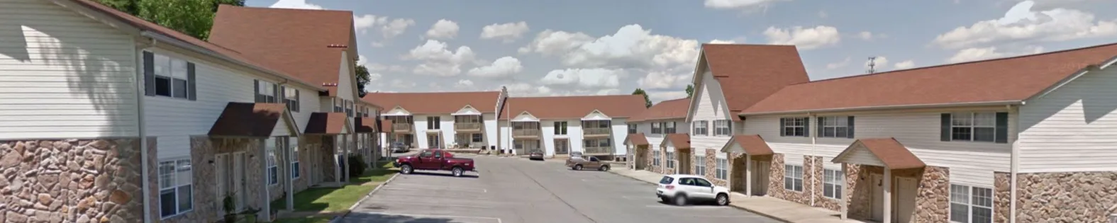 a google street view image of a parking lot at The Country Oaks Apartments